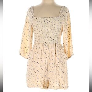 American Eagle size medium cream colored romper with blue flowers
